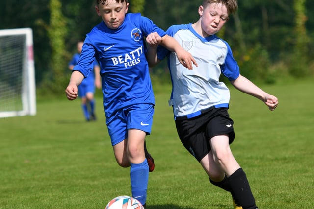 Ballinamallard United's Robbie Benson holds off Oxford United's Aaron O'Kane during their under-9's match on Monday. Picture by Keith Moore