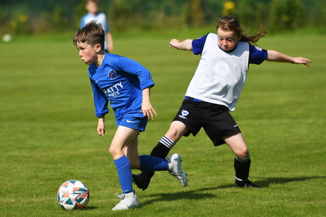 Ballinamallard United player Alastair McCreesh skips past Oxford United's Mia McDaid during their under-9's match on Monday. Picture by Keith Moore