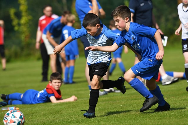 Reece Hargan, Oxford United under-9's in a race for the ball with Ballinamallard United defender Daithi King at Oakgrove on Monday. Picture by Keith Moore