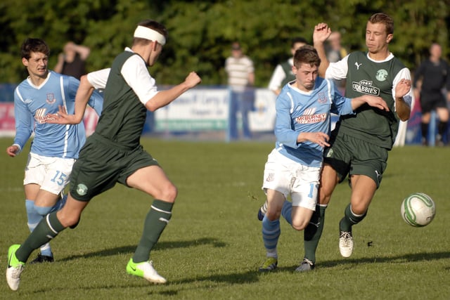 Ballymena United's Peter Duffin battles his way past two Hibernian defenders during their Foyle Cup Under-19's final on Friday night. 2407JM04