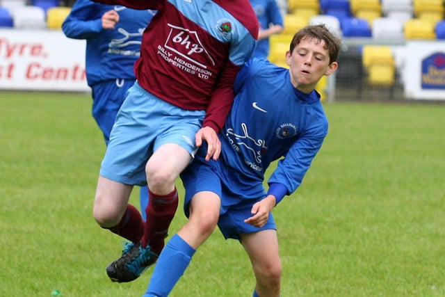 Institute’s Mathew Lynch, fights to keep control of the ball against Ballinamallard’s Connor Keys, in their Foyle cup under 14 game at the Riverside Stadium.  INLS 1230-525MT.