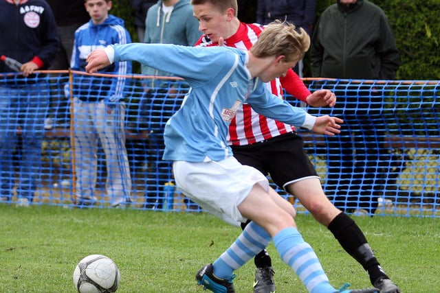 The Derry City player slips past Ballymena’s Jamie Ross, during action in their Foyle cup under 19 game at McCourt’s INLS 1230-536MT.