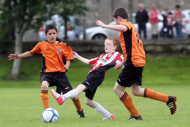 ©/Lorcan Doherty Photography -  July 21th 2012. 

Hughes Insurance Foyle Cup U-12 Plate Final. Derry and District Youth FA V Cavan Monaghan Youth League. Derry's Conor McGowan and Cavan Monaghan's Eli Ward and Tiernan Duffy.

Photo Credit Lorcan Doherty Photography