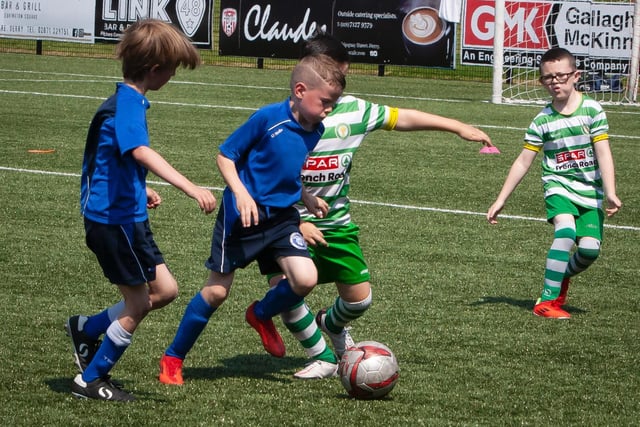 Trojans striker holds off the Top of the Hill Celtic defender during Monday's O'Neill Foyle Cup U8 game. Picture by Jim McCafferty
