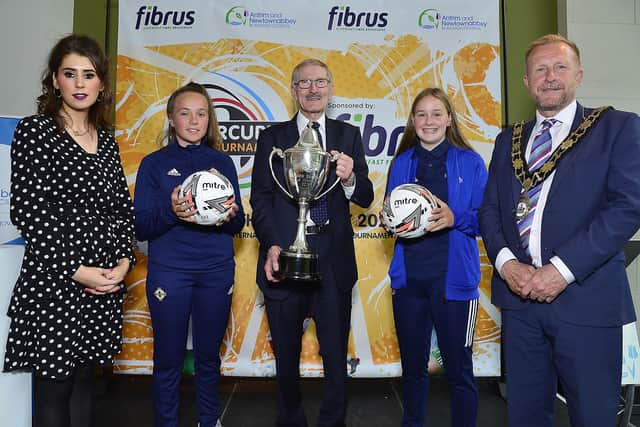 Ald Stephen Ross, Victor Leonard (chairman of the organising committee of SuperCupNI), Amie McNiece (Marketing Director at Fibrus) alongside young players.