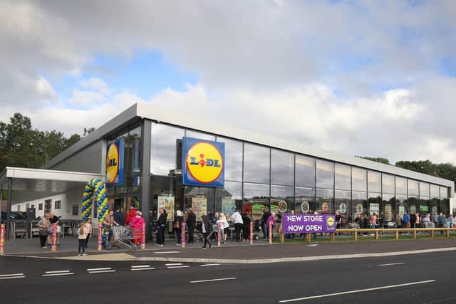 Shoppers queue to get in to the new Lidl store at Shore Road.