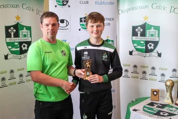 Joe Kelly presents Owen Glass with his award for 2010s Players' Player of the Year.
