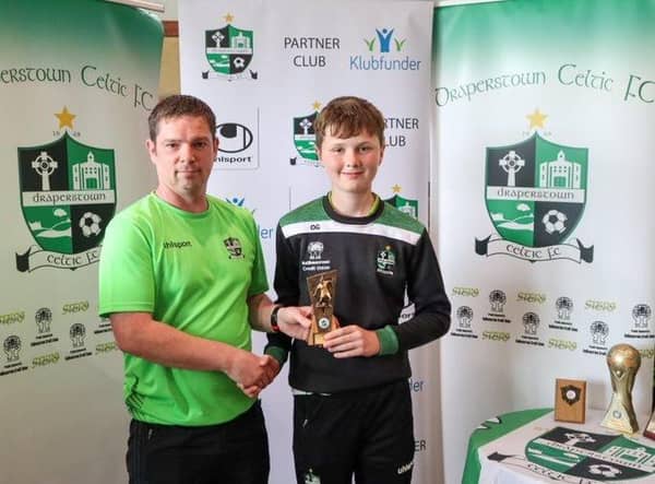 Joe Kelly presents Owen Glass with his award for 2010s Players' Player of the Year.