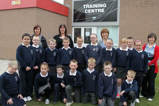 Pupils from Harryville Primary School who visited Wrightbus, Galgorm where they take part in the 'Time To Read' programme. Included are Moira Park and Ann McVeigh from Wrightbus and the pupils' classroom assistant Mrs Millar. BT17-140JC