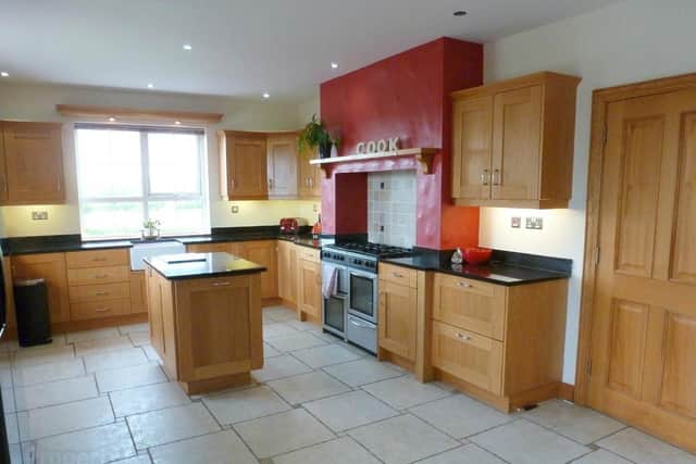 This property has a striking kitchen and dining area with a range of solid oak Shaker style units