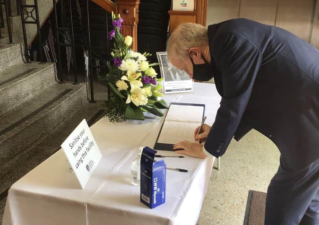 MP Gregory Campbell signing the book of condolences at Coleraine Town Hall