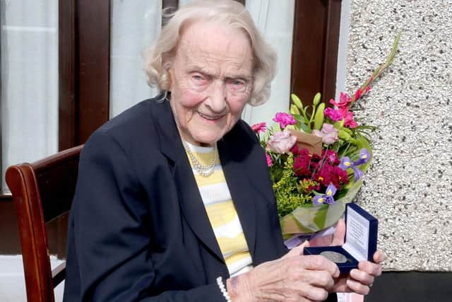 100-year-old Isabelle Claypole displays her commemorative centenary coin received from the Mayor of Causeway Coast and Glens Borough Council Alderman Mark Fielding