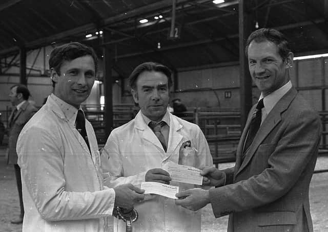 Championship cheques at the Landrace show and sale at Ballyclare being handed over to the winners by Mr Eddie Brett, manager of the Ballymena branch of the Bank of Ireland, which sponsored the special prizes at Ballyclare in April 1980. On the left is Mr Cyril Millare from Coleraine (£30 for supreme champion) and Mr Robert Overend, Bellaghy (£20 for reserve). Picture: Farming Life archives