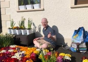 Thumbs up from Ben, surrounded by his beautiful flowers