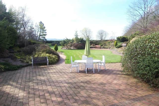 The mature gardens and plot extends to approximately 2 1⁄2 acres comprising an array of landscaped rockeries, flowerbeds, feature pond and various patio/bbq areas.