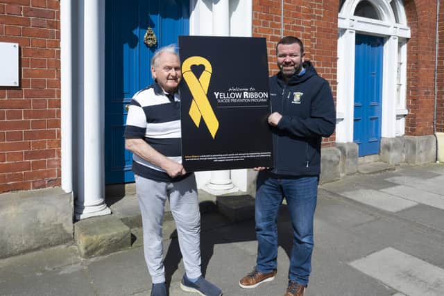 Portadown Rugby Football Club President Ciaran O'Kane and Dr. Arthur Cassidy of Yellow Ribbon.