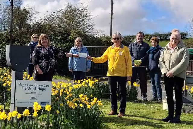 Cairncastle Community Association presented a cheque to Marie Curie UK .