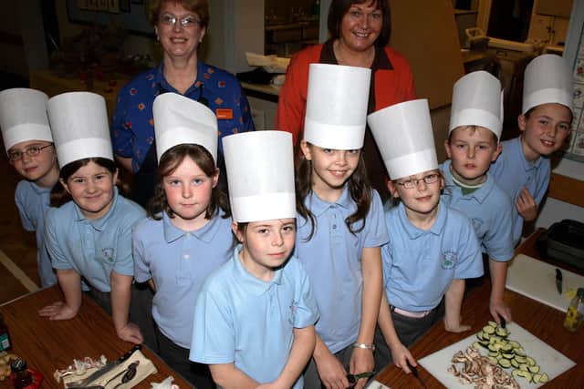 Pupils from Ballee Primary School, who are members of the school's new Cookery Club are seen here with Sainsbury's Food Advisor Linda McKeown and teacher Mrs Lynn. BT46-104JC