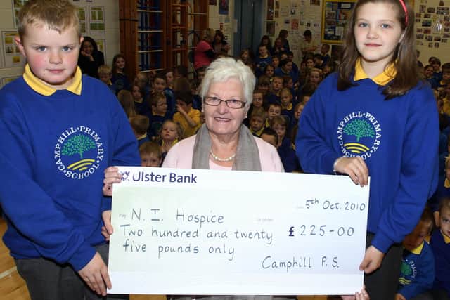 Camphill Primary School pupils Daniel Winters and Amy Topping present a cheque for £225 (proceeds of a coffee morning held in the school) to Rosemary Kennedy of the Ballymena Hospice Support Group. BT41-100JC