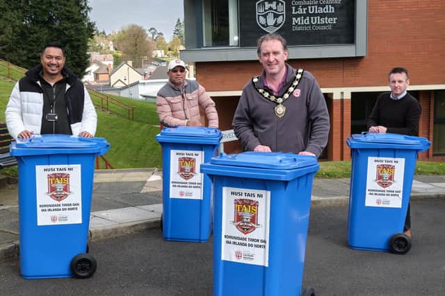 The Chair of Mid Ulster District Council, Councillor Cathal Mallaghan is pictured with members of TAIS (Timorese Association Inclusive Support) and Peace and Good Relations officer from the Council, with some of the household recycling bins donated to the East Timor aid relief.