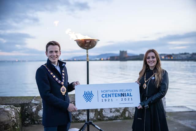 Mayor and Mayoress of Mid and East Antrim, Peter and Tory Johnston, pictured as the beacon was lit at Fisherman's Quay in Carrickfergus for the NI centenary.