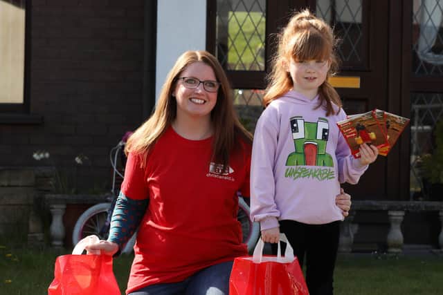 Seven-year-old Lily Swann with her mum Lorna, preparing to resume their Christian Aid Week house-to-house collection in Glynn, near Larne.