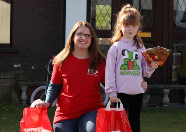 Seven-year-old Lily Swann with her mum Lorna, preparing to resume their Christian Aid Week house-to-house collection in Glynn, near Larne.