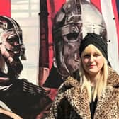 Kim in front of a Viking themed public artwork panel commissioned by Mid and East Antrim Borough Council and Larne Renovation Generation. The original painting was photographed by Bernie McAllister of Argyll Images.