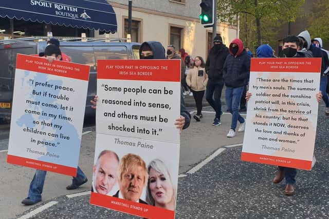 Placards citing Thomas Paine gathers at a rally against the Irish Sea customs border in Markethill on May 5, 2021.