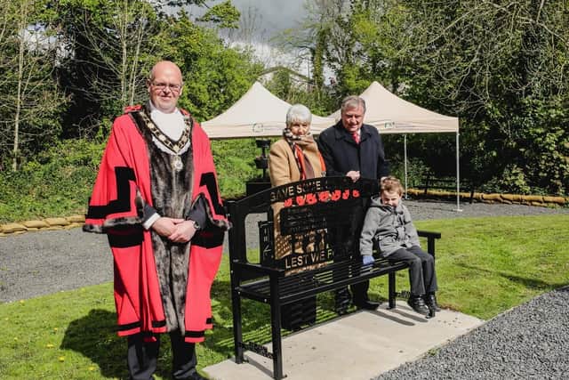 The Mayor of Antrim and Newtownabbey, Councillor Jim Montgomery,  with Alderman Dr Fraser Agnew MBE and his wife Lyla and grandson Joel at his new bench in Campbell Memorial Garden.