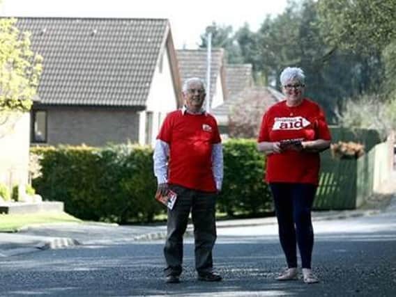 (L-R) Kelvin McCracken and June McDowell prepare to resume their annual Christian Aid Week house-to-house collection as lockdown restrictions ease