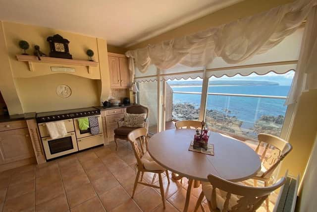 The kitchen/diner has sliding patio doors on to the tiled veranda