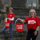 Friends Louise McGregor (left) and Susan Wilson prepare to walk for 5 kms while carrying buckets of water, in solidarity with women and girls in drought-affected parts of rural Africa who walk for hours each day to fetch water for their families and livestock