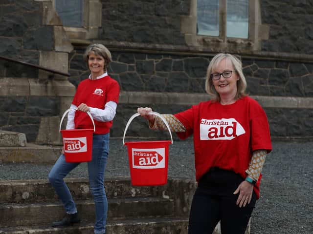 Friends Louise McGregor (left) and Susan Wilson prepare to walk for 5 kms while carrying buckets of water, in solidarity with women and girls in drought-affected parts of rural Africa who walk for hours each day to fetch water for their families and livestock