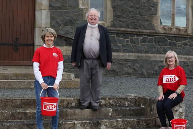 Annahilt Christian Aid supporters Louise McGregor (left) and Susan Wilson prepare to begin their walk for water challenge watched on by their rector, Canon Robert Howard