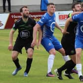 Loughgall defender John Scott (right) keeping his focus to help secure Saturday's Irish Cup win. Pic courtesy of Loughgall FC.