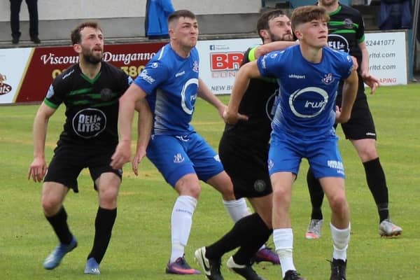 Loughgall defender John Scott (right) keeping his focus to help secure Saturday's Irish Cup win. Pic courtesy of Loughgall FC.