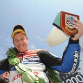 Honda TT Legends rider John McGuinness celebrates winning the opening Superbike race at the 2012 North West 200.