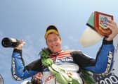 Honda TT Legends rider John McGuinness celebrates winning the opening Superbike race at the 2012 North West 200.