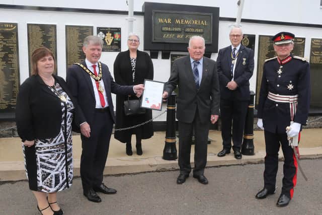 Bobbie Davis receives a certificate of recognition for his commitment to the Poppy Appeal alongside the Mayor of Causeway Coast and Glens Borough Council Alderman Mark Fielding, Mayoress Mrs Phyliss Fielding, Sue Pinkerton, John Pinkerton and the Lord-Lieutenant for County Antrim Mr David McCorkell