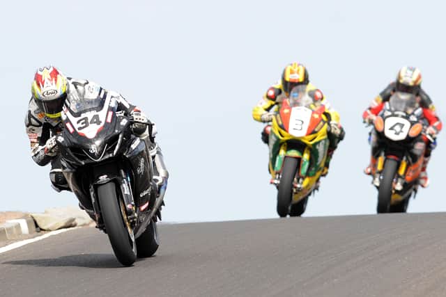 Alastair Seeley (Relentless Suzuki) leads Stuart Easton (Swan Honda) and John McGuinness (HM Plant Honda) over Black Hill on his way to victory in the feature race at the North West 200 in 2010.