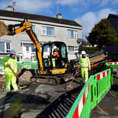 A friendly T-Rex, aka Harvey, confronts gas workers in Cookstown.