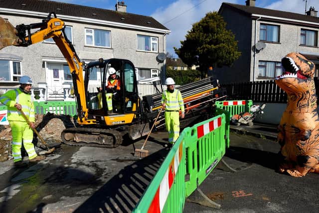 A friendly T-Rex, aka Harvey, confronts gas workers in Cookstown.
