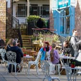 People relax in the Craft Village on Friday morning as cafes reopened. Photo: George Sweeney / Derry Journal.  DER2117GS  045