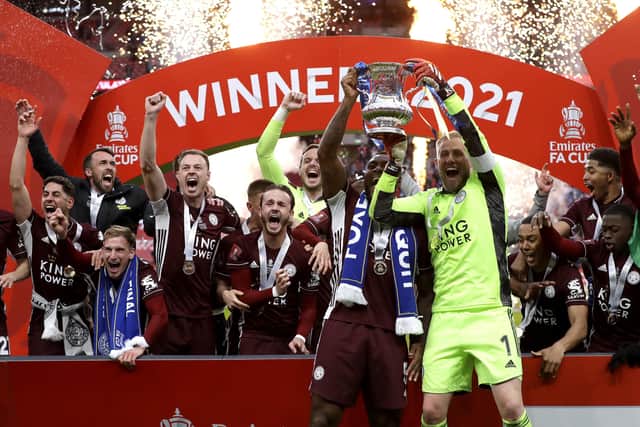 Leicester City's Wes Morgan (left) and Kasper Schmeichel lift the trophy as they celebrate winning the Emirates FA Cup Final at Wembley Stadium, London. Picture date: Saturday May 15, 2021.