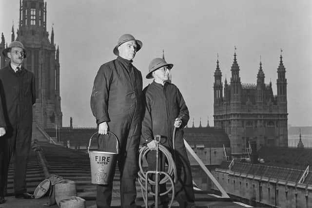 Staff and members of the Palace of Westminster Company (C Company 35th London (Civil Service) Battalion) Home Guard carry out fire watch duty to guard against incendiary bombs on the roof of the House of Lords in November 1942 at London, United Kingdom.  (Photo by Bill Brandt/Picture Post/Hulton Archive/Getty Images)