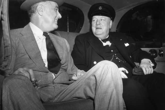 British Prime Minister Winston Leonard Spencer Churchill (1874 - 1965) with Franklin Delano Roosevelt (1882 - 1945) 32nd President of the United States, seated in a car on their way to the White House in Washington to discuss the Allied Victory in North Africa.   (Photo by Topical Press Agency/Getty Images)