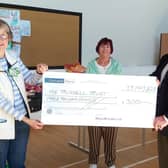 Mark McCalmont, president of Ballyclare Rugby Club, presenting a cheque for £3000 to Eleanor Abraham (left) and Yvonne Houston