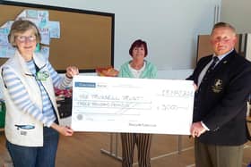 Mark McCalmont, president of Ballyclare Rugby Club, presenting a cheque for £3000 to Eleanor Abraham (left) and Yvonne Houston