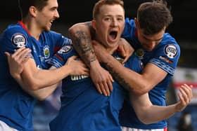 Shayne Lavery (centre) grabbed the Irish Cup final spotlight by breaking the deadlock in Lurgan for Linfield over Larne. Pic by Pacemaker.